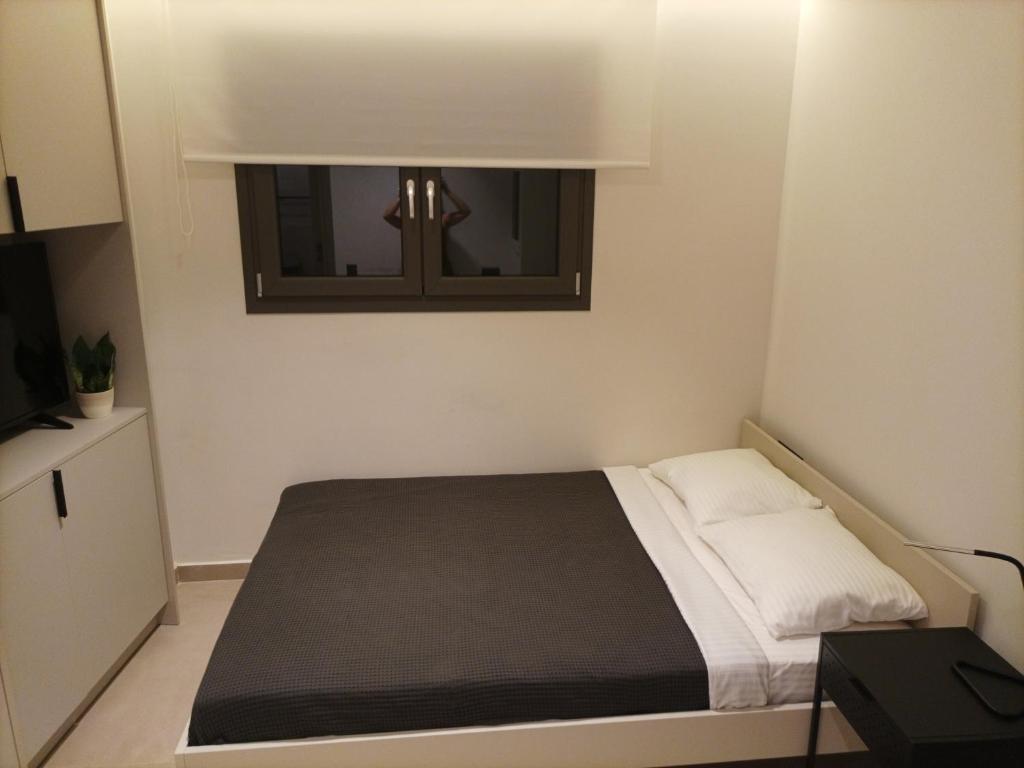 A bed or beds in a room at Evripidou Experience - The smart double C