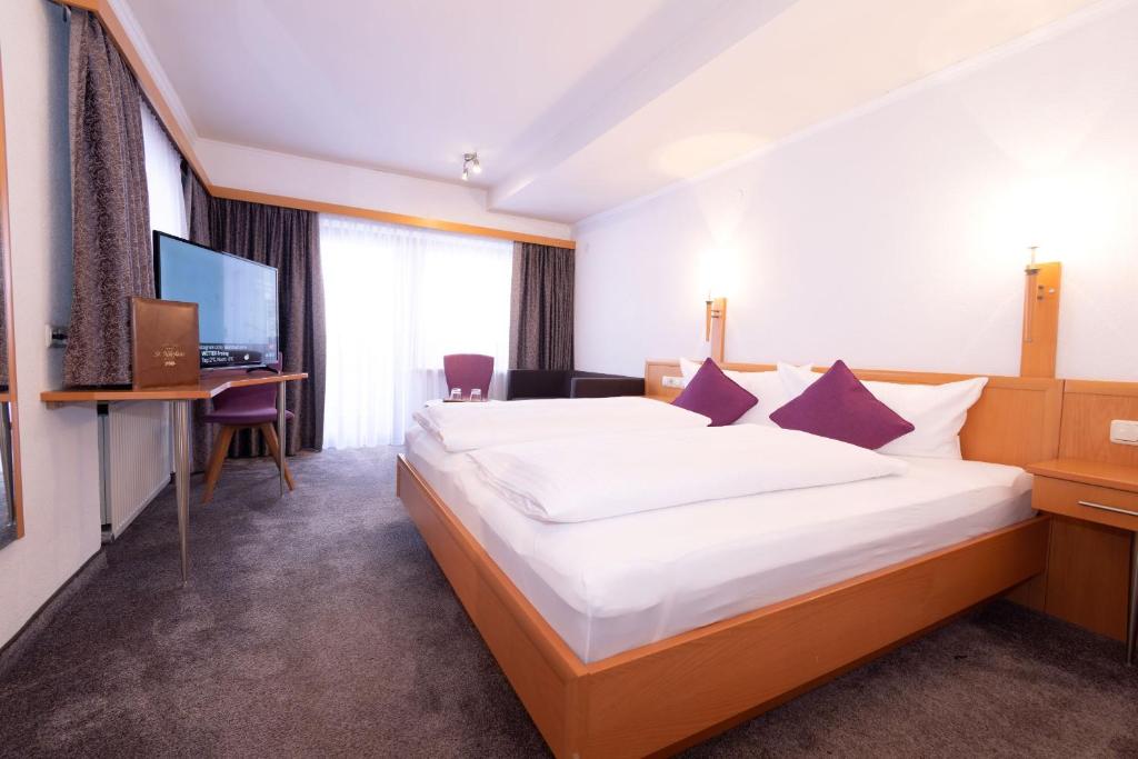 Postel nebo postele na pokoji v ubytování Hotel St. Nikolaus