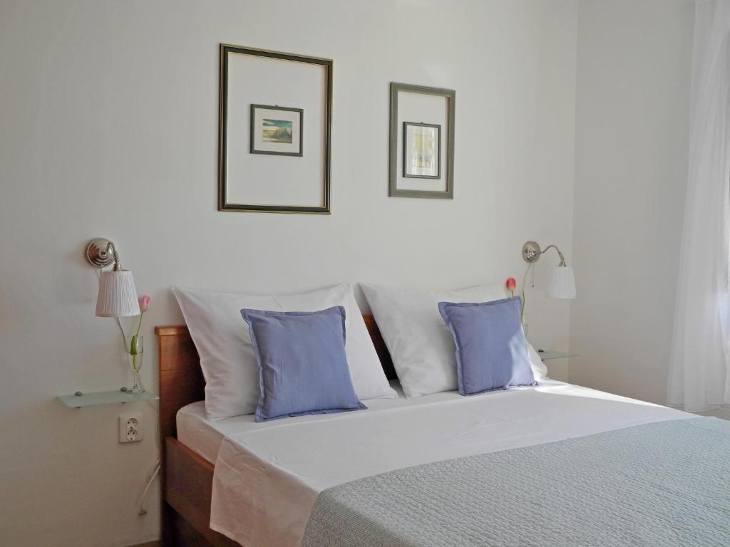 a bedroom with a large bed with blue pillows at Apartments & Room Paula in Split