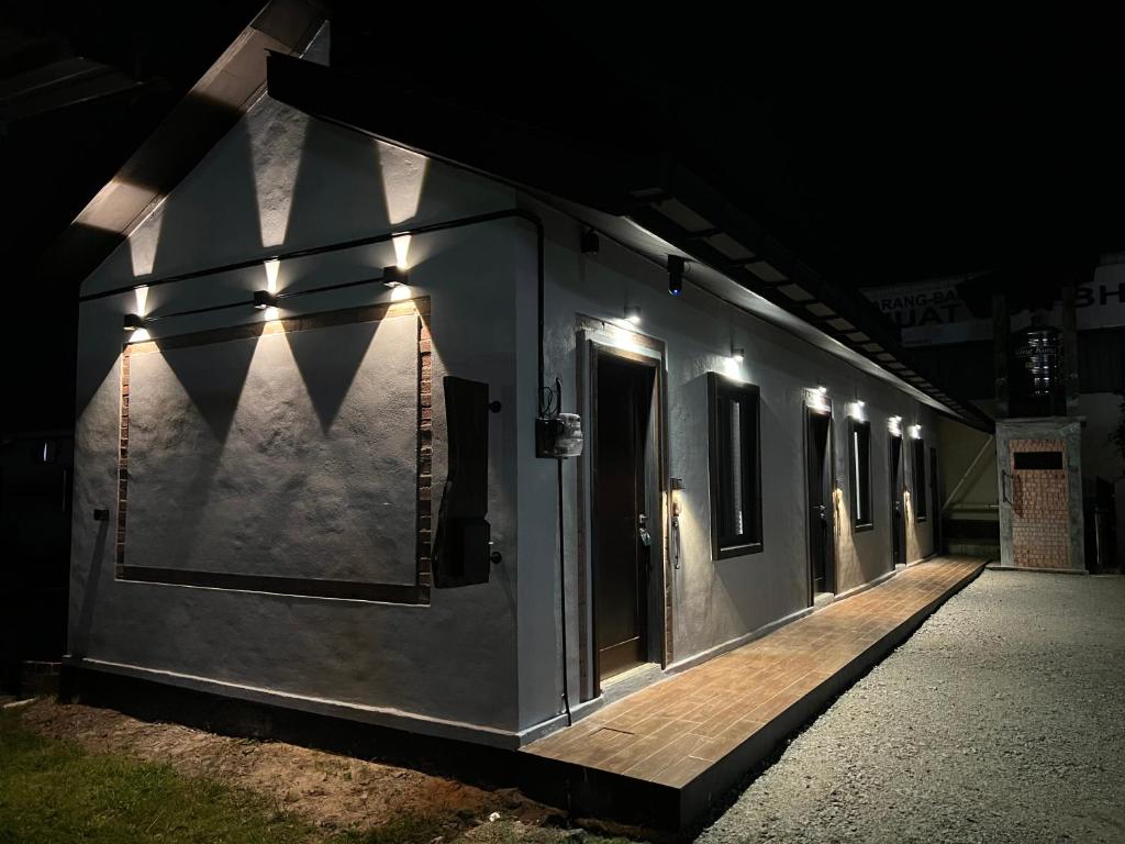 a train car lit up at night with lights at ZUSCH STUDIO in Pantai Cenang