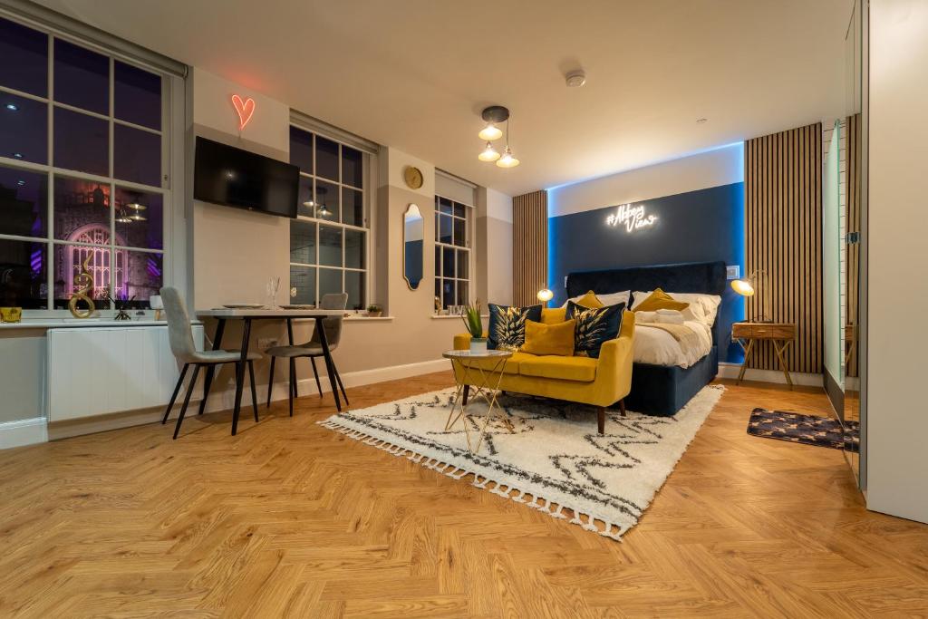 a living room with a yellow couch and a table at Abbey View studio central Bath in Bath