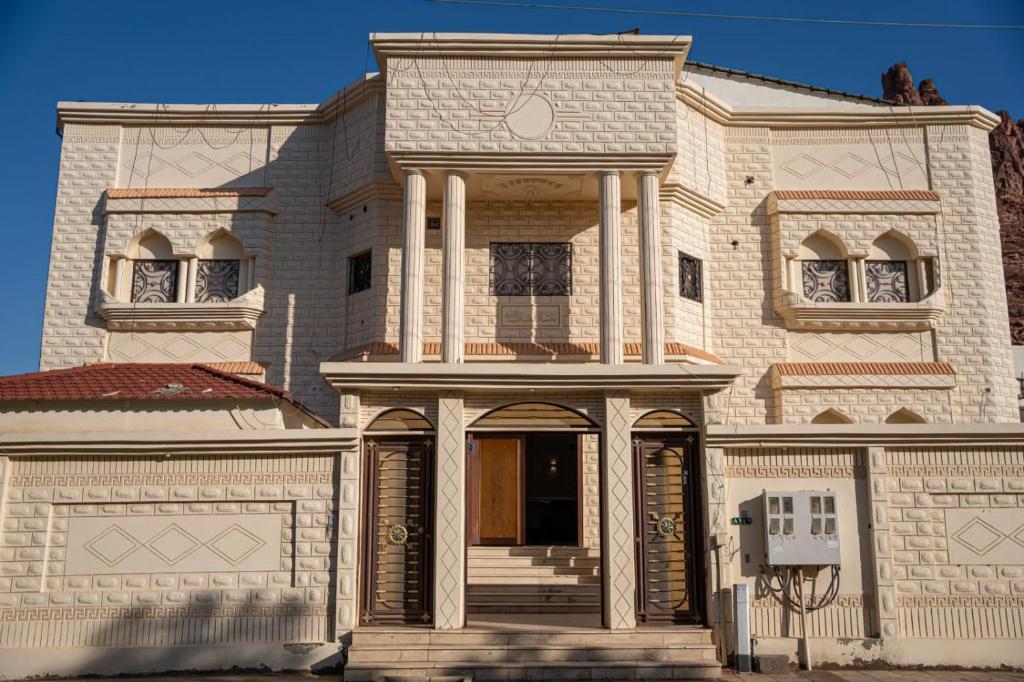 a large house with columns on the front of it at Classic Hotel in Al-ʿUla