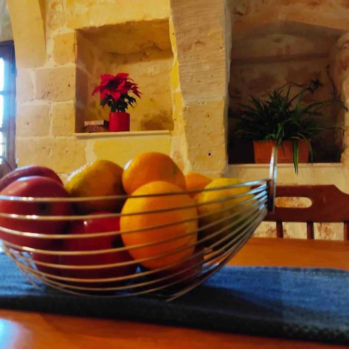 a bowl of fruit sitting on a table at Ta’ Peppi Farmhouse in Qala