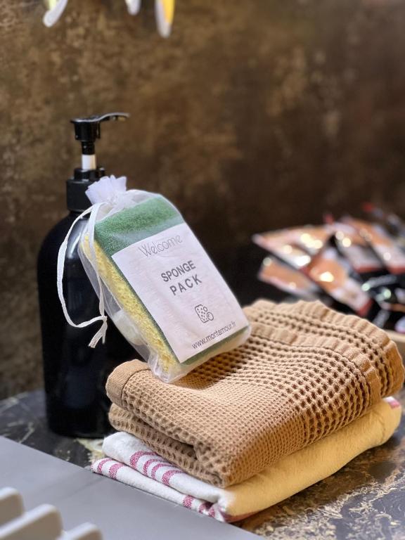 a bottle of soap sitting on top of towels at Les Trois Chaufatons - Chalets Boutiques in Montriond