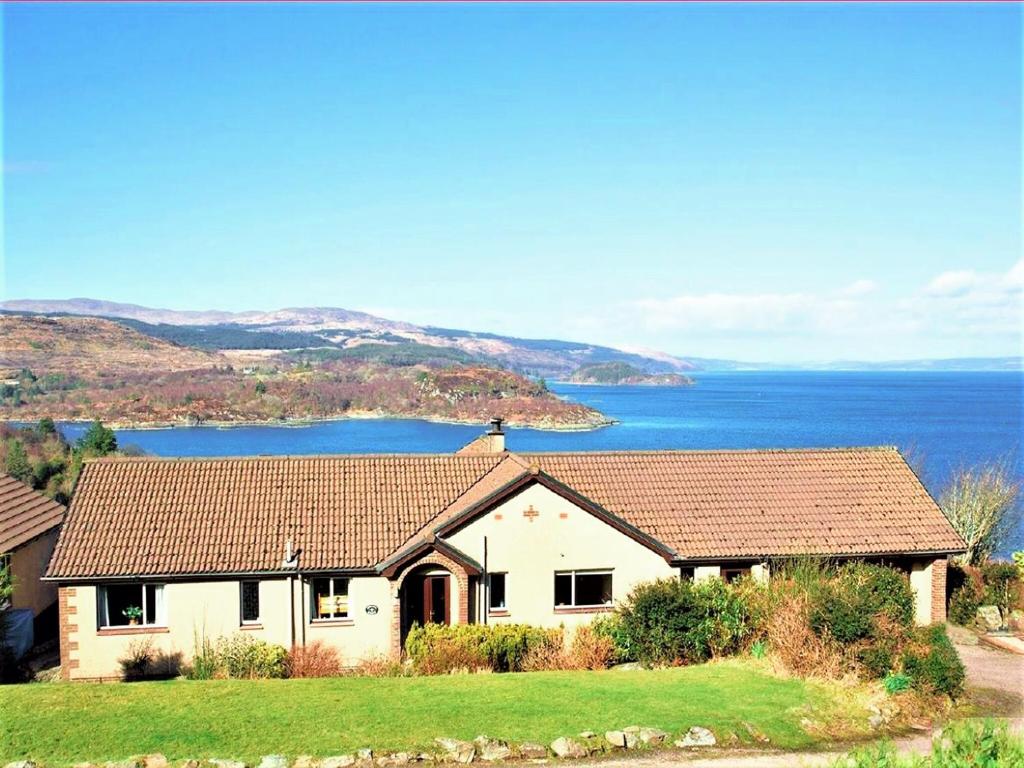 a white house with a view of the water at Devana Croft in Tarbert