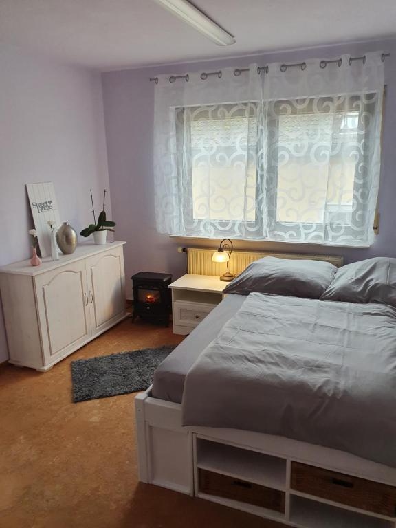 a bedroom with a large bed and a window at 5 Zimmer Appartement in ruhiger Lage nähe Heilbronn in Oedheim