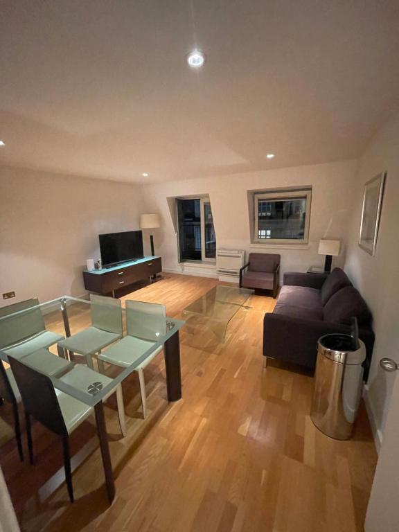 a living room with a couch and a table at Oxford Street Apartment in London