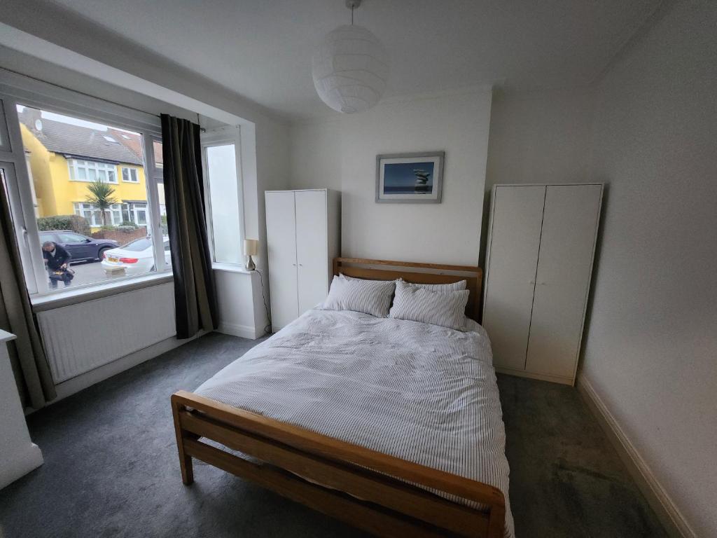 a bedroom with a bed and a large window at Guest rooms in London