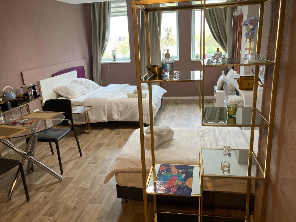 a room with a bed and a room with a mirror at « Le Val d AuRS »Calme et élégance in Strasbourg
