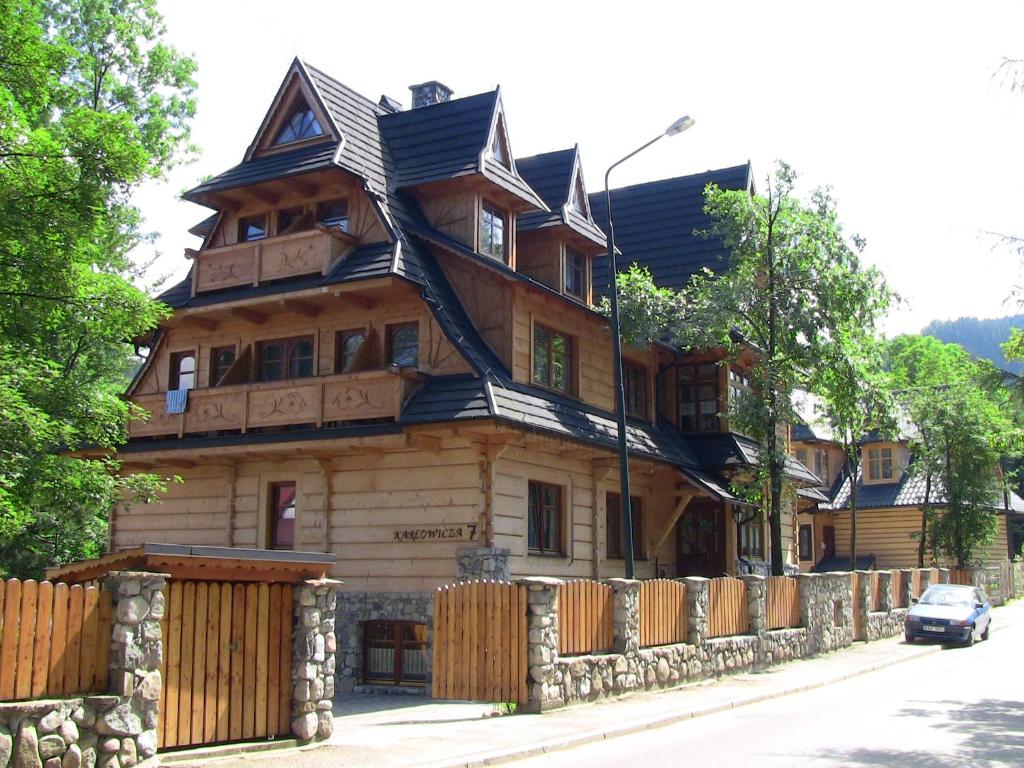 a large wooden house with a fence in front of it at Willa Bystry, Pod Nosalem in Zakopane