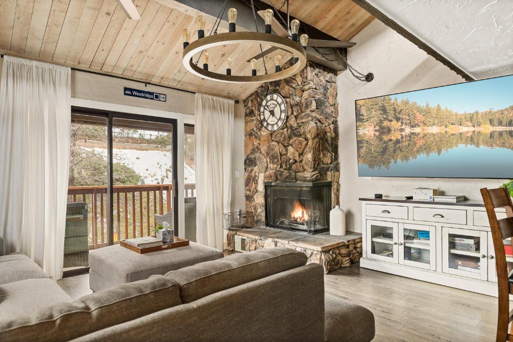 a living room with a couch and a fireplace at First Class Location in Big Bear Lake