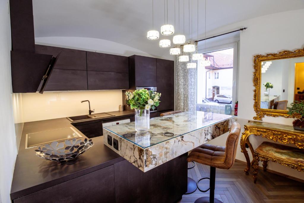 a kitchen with a counter with a vase of flowers at Central Living Vegova-with parking in Ljubljana
