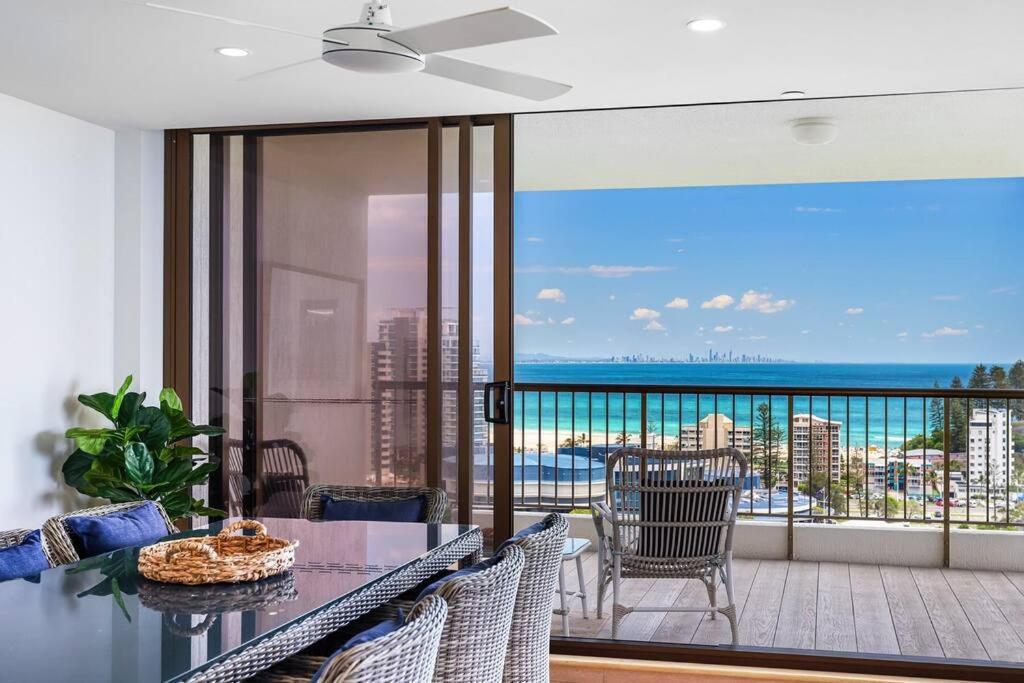 a dining room with a balcony with a view of the ocean at Bay View in Tweed Heads