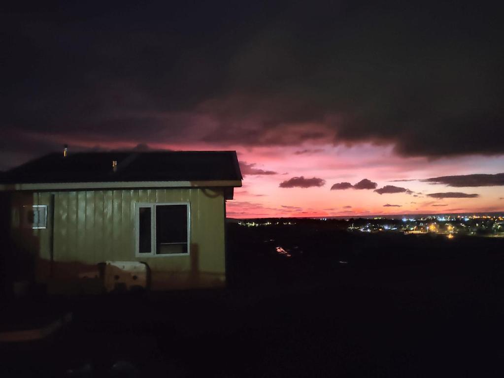 a building with a sunset in the background at atenea in Punta Arenas