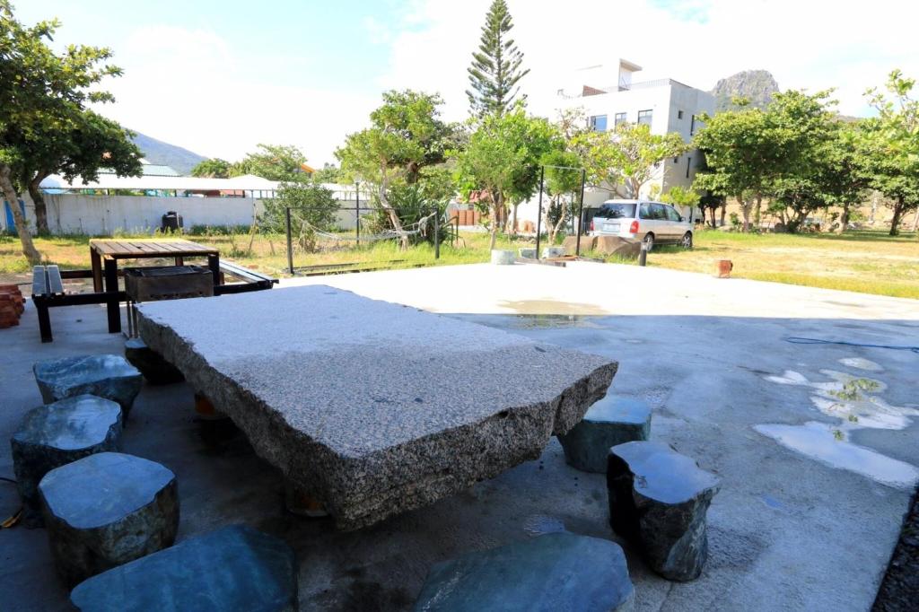 a stone table and stools in a park at Kenting Peninsula Inn in Kenting
