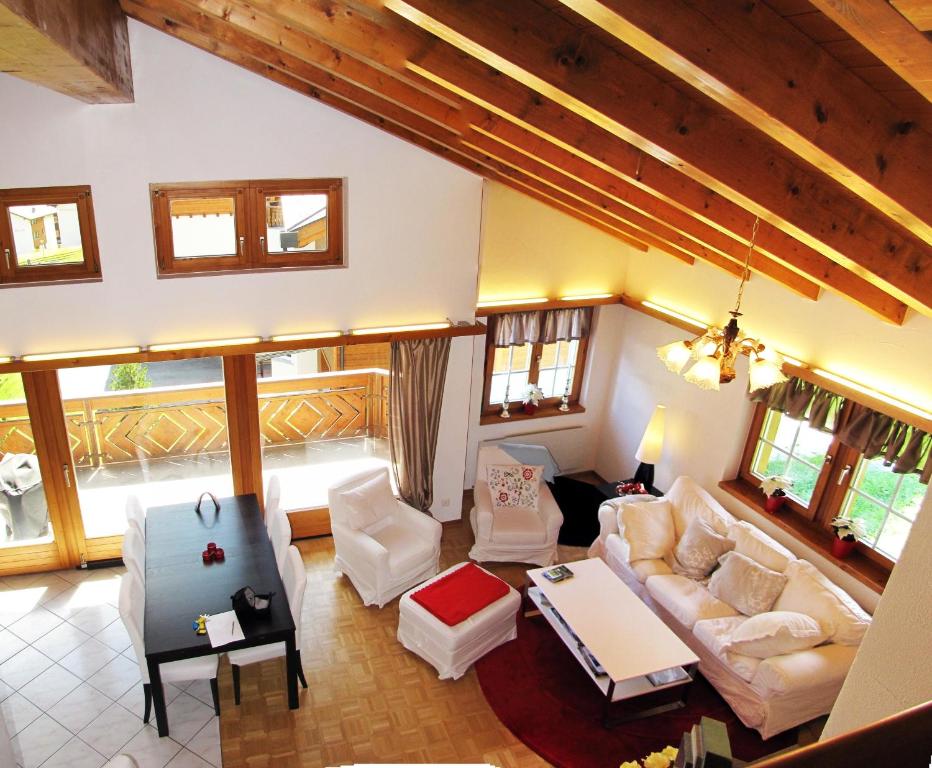 an overhead view of a living room with white furniture at Flamingo in Saas-Fee