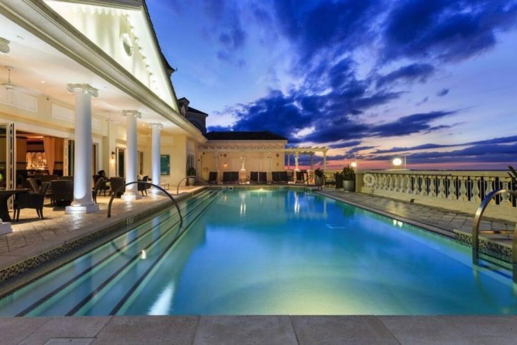 a swimming pool in front of a building at MINUTES FROM DISNEY 3bed 3bath Poolside at LUXURIOUS RESORT in Kissimmee