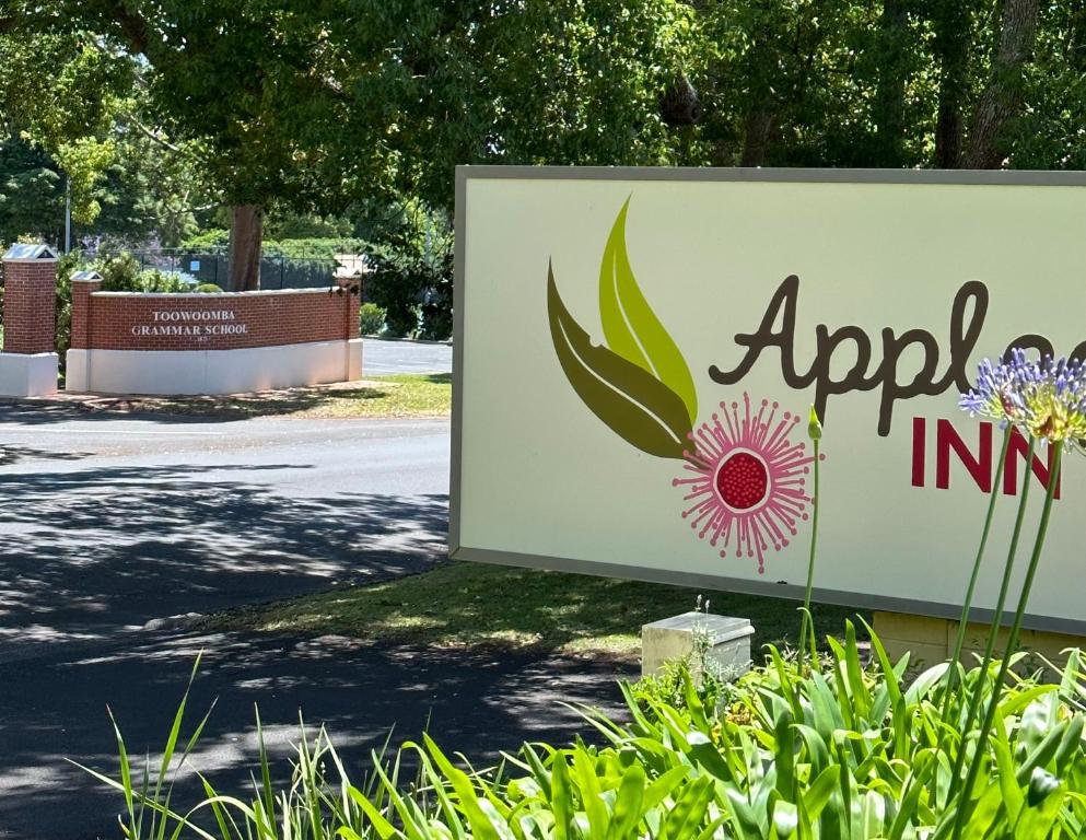a sign for anapril inc with a flower on it at Applegum Inn in Toowoomba