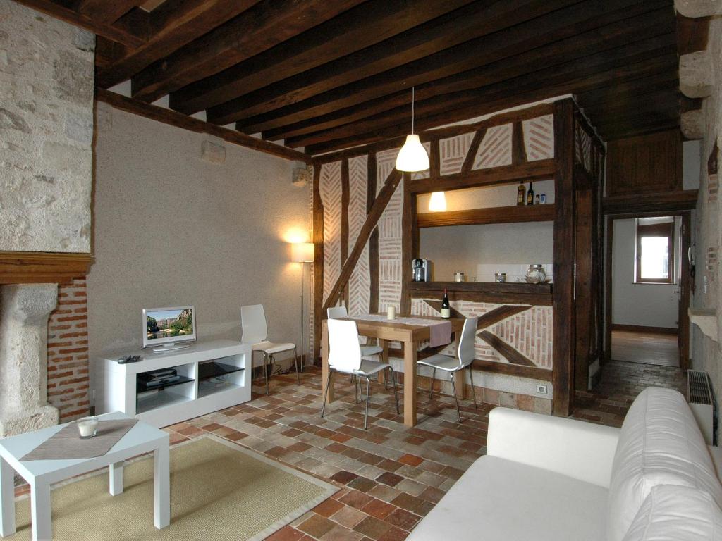 a living room with a couch and a table at Appart'Tourisme Blois Châteaux de la Loire in Blois