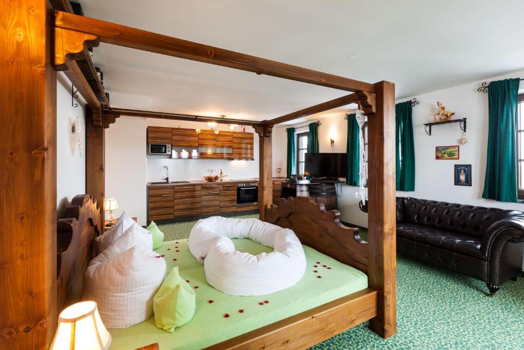a living room with a couch and a bed with chairs at Vitusfort Appartement "Irish Whisky Suite" in Füssen
