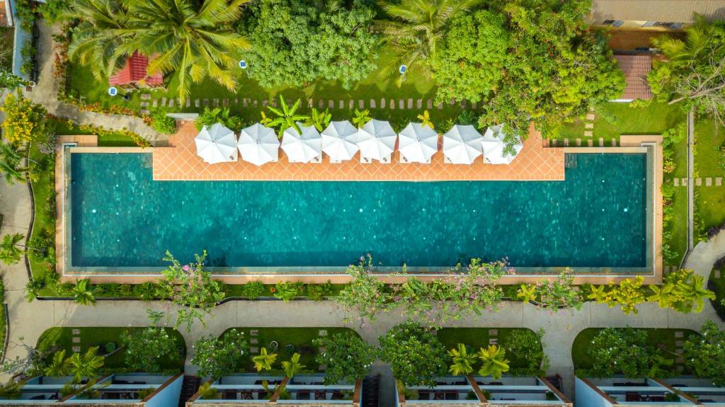 an overhead view of a swimming pool with lounge chairs at Khmer House Resort in Siem Reap