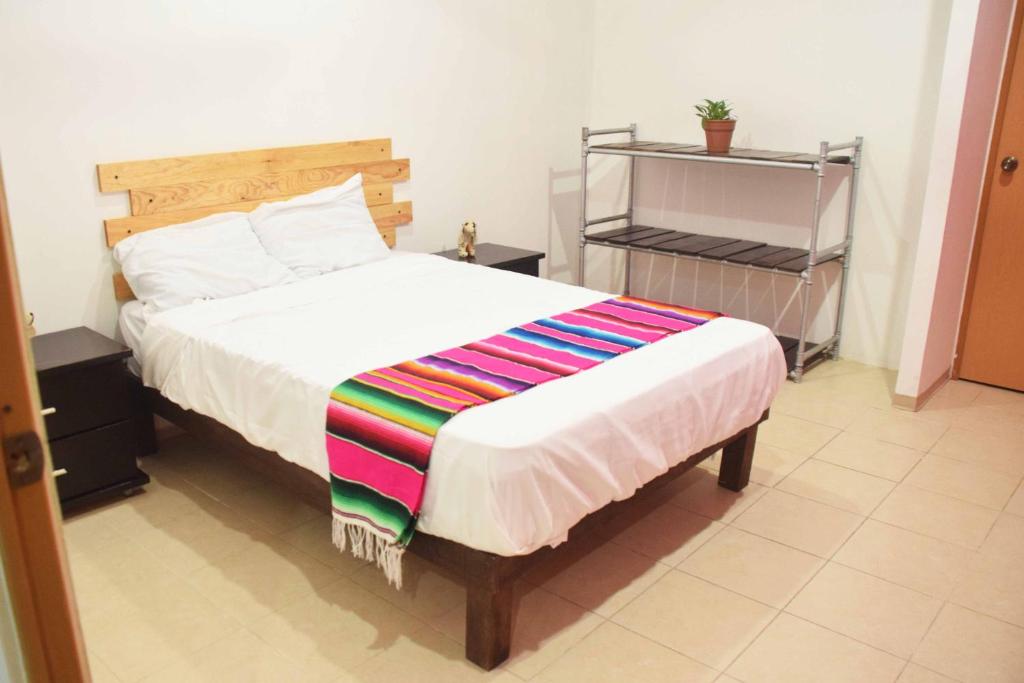 Postel nebo postele na pokoji v ubytování Hostal Casa Bohemia