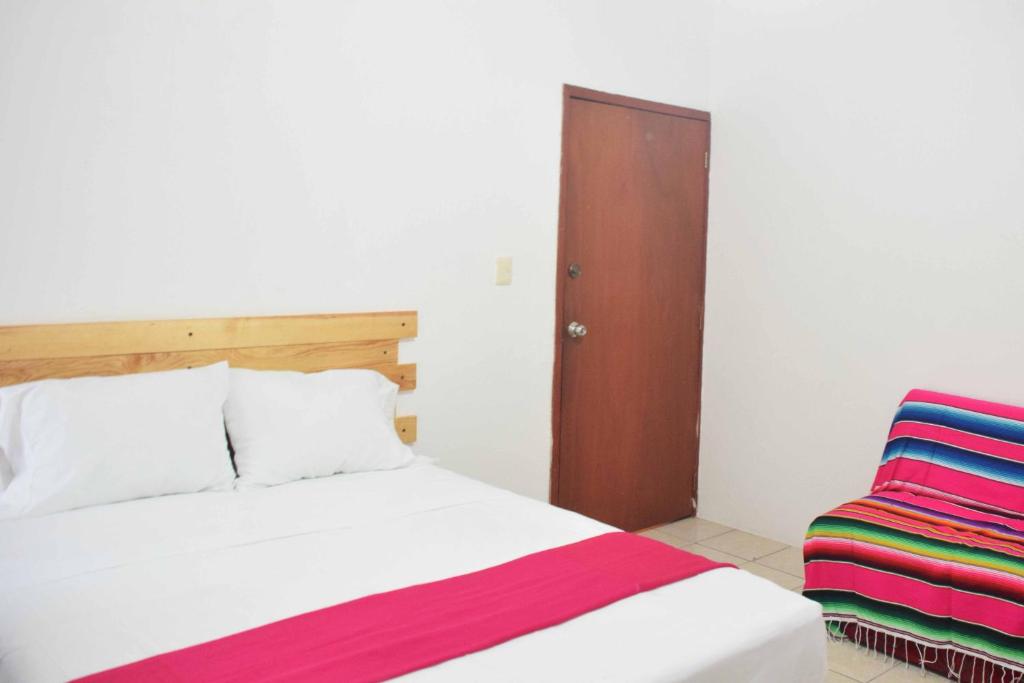 Postel nebo postele na pokoji v ubytování Hostal Casa Bohemia