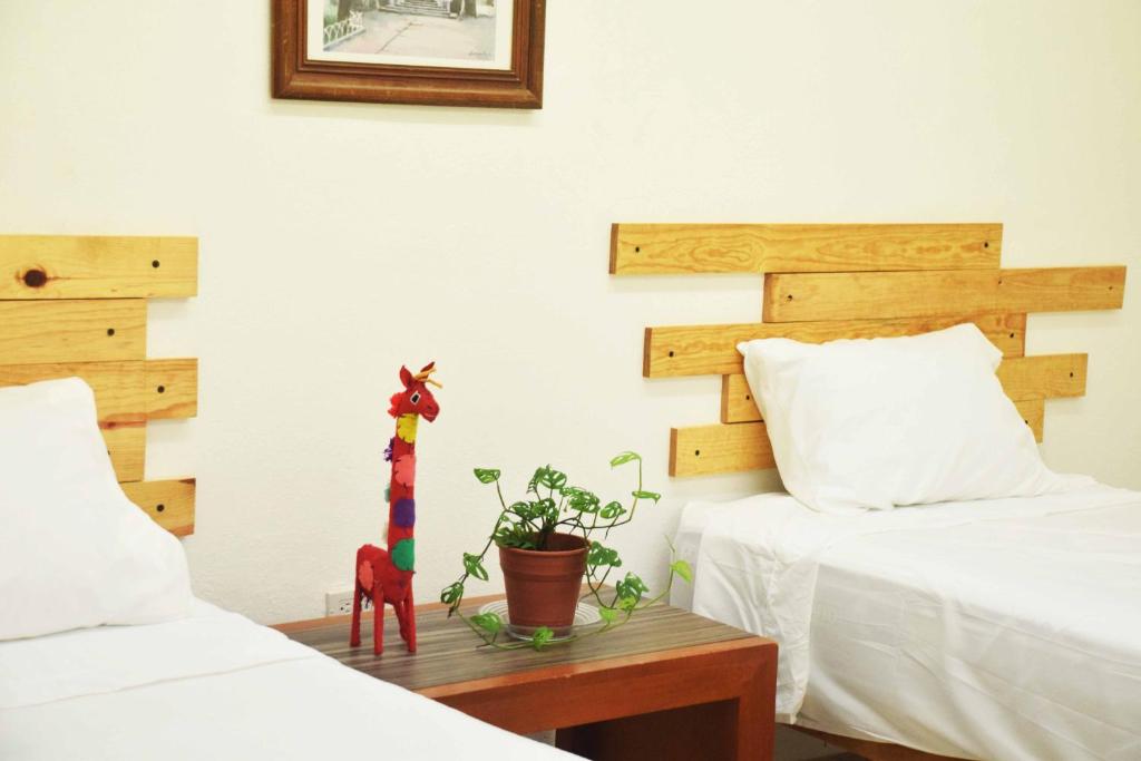 Postel nebo postele na pokoji v ubytování Hostal Casa Bohemia