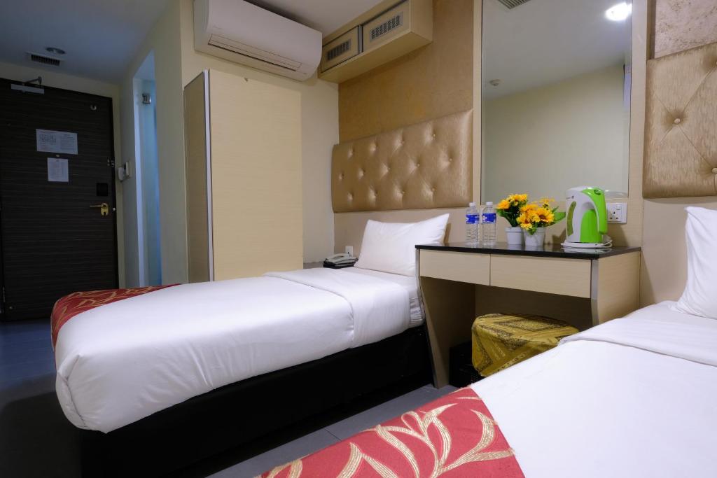 Postel nebo postele na pokoji v ubytování Sandpiper Hotel Singapore