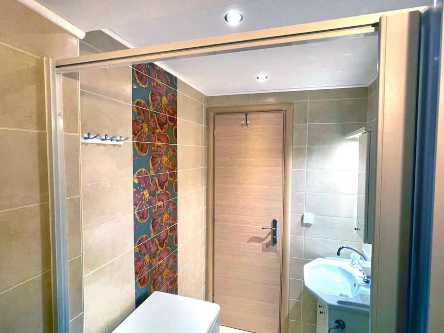 een badkamer met een douche, een toilet en een wastafel bij Villa Simotas 4 Four in Póros