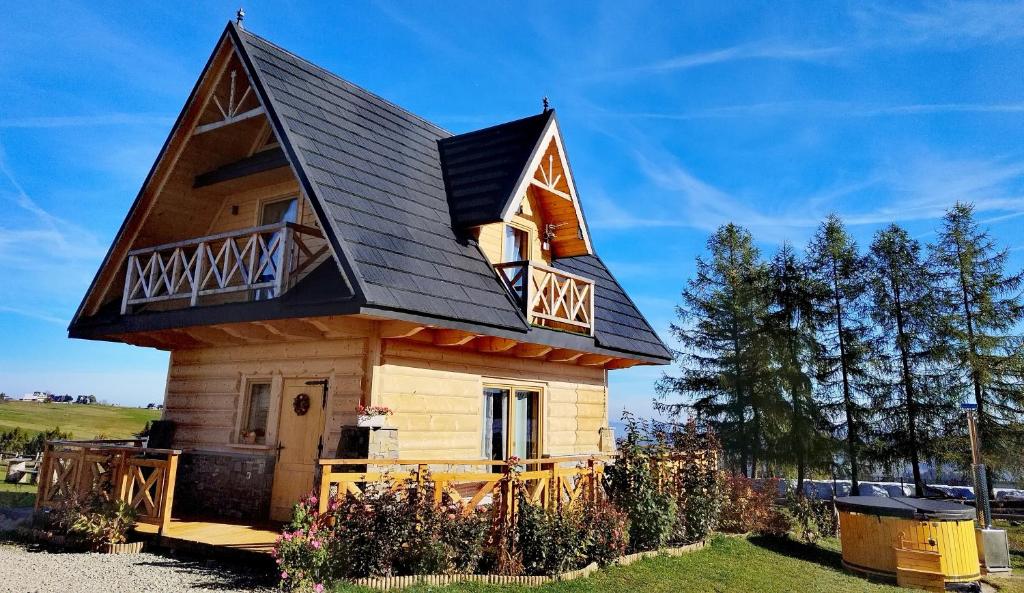 une petite maison avec un toit en gambrel dans l'établissement Zymbiańsko Chałupa z balią na wyłączność, à Ząb