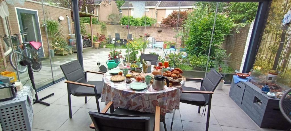 a table with food on it on a patio at B&B Acacia in Goirle