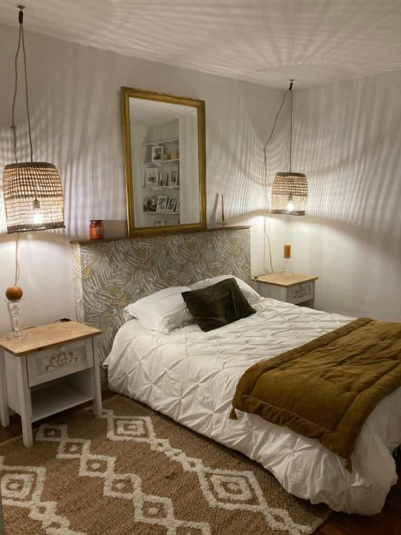 a bedroom with a bed with two tables and a mirror at CAEN : appartement Cosy hyper centre historique in Caen