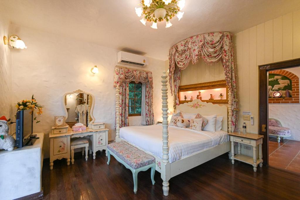 a bedroom with a bed and a large mirror at Swiss Valley Hip Resort in Suan Phung