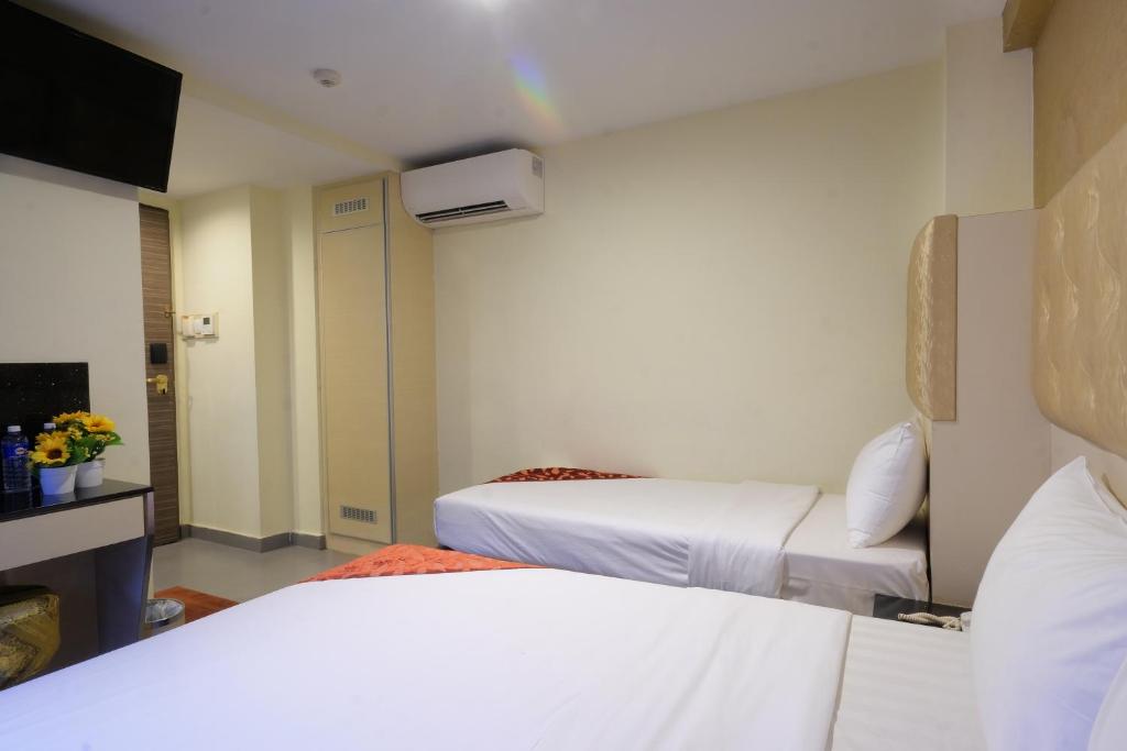 Postel nebo postele na pokoji v ubytování Sandpiper Hotel Singapore