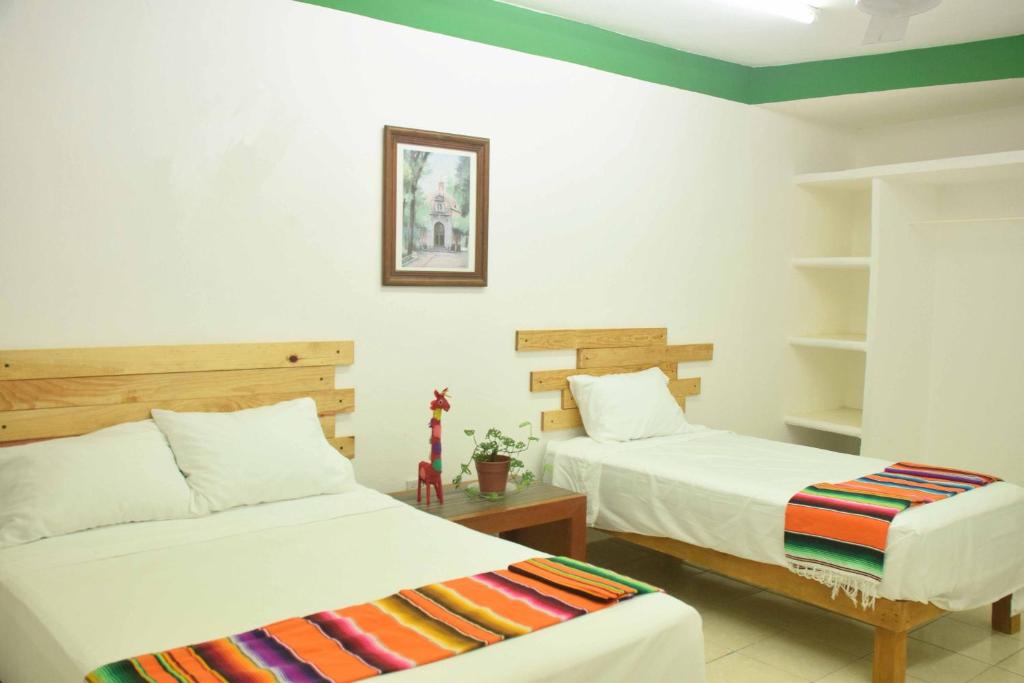 Postel nebo postele na pokoji v ubytování Hostal Casa Bohemia