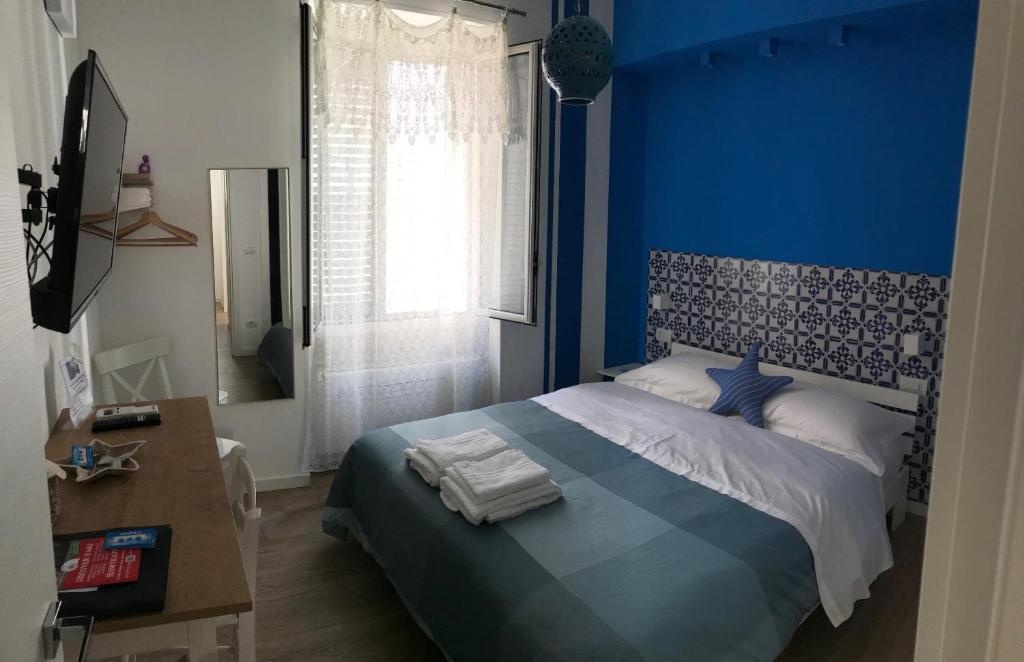 a blue bedroom with a bed with a blue wall at B&B Via dell'Azzurra in Bari