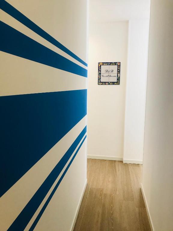 a room with blue and white stripes on the wall at B&B Via dell'Azzurra in Bari