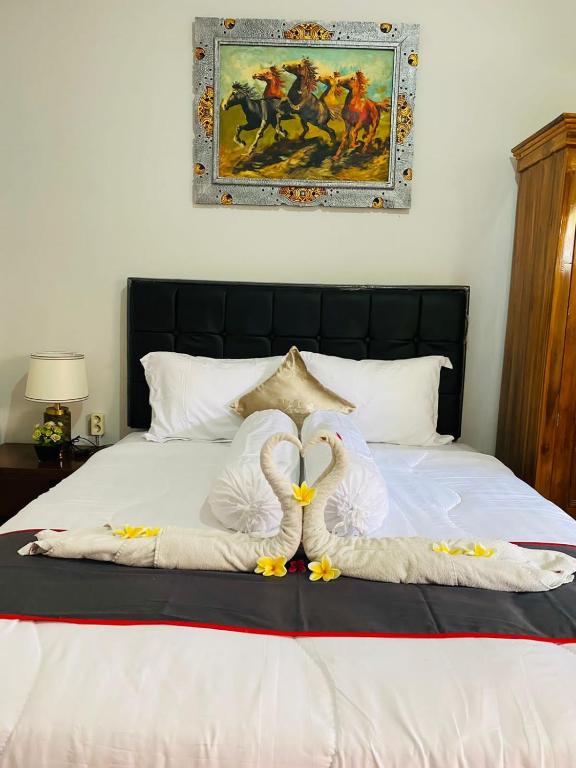 Postel nebo postele na pokoji v ubytování Guest House Pondok Puspa Ayu