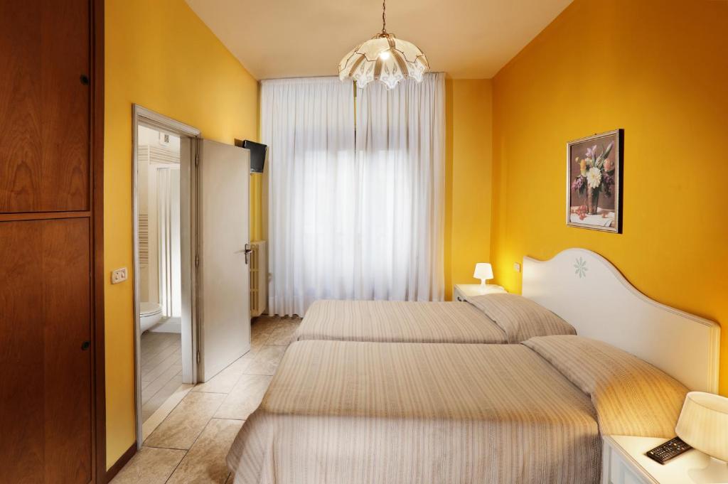 Postel nebo postele na pokoji v ubytování Hotel La Querceta