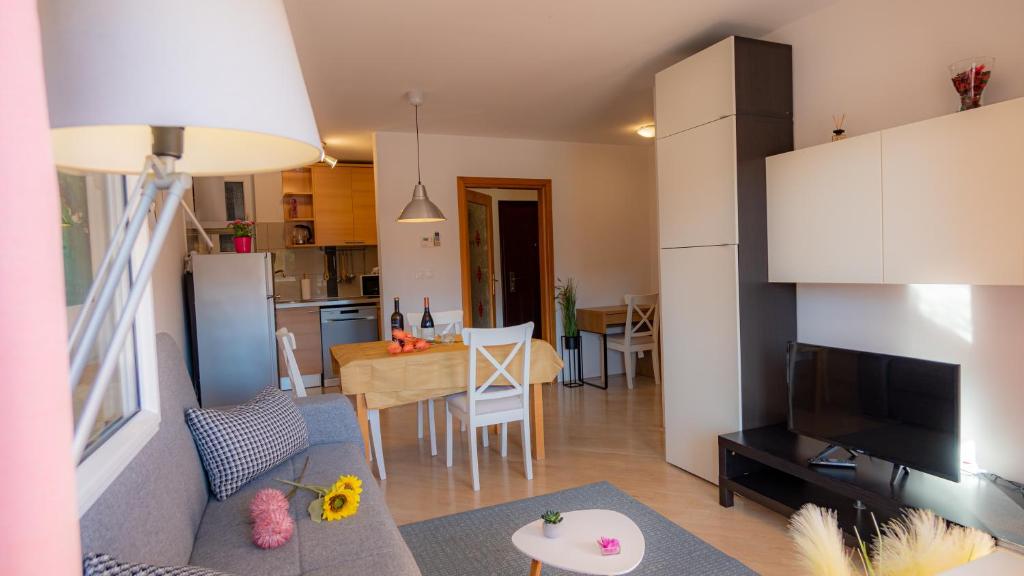 a kitchen and a living room with a dining room at 1st floorC in Pula