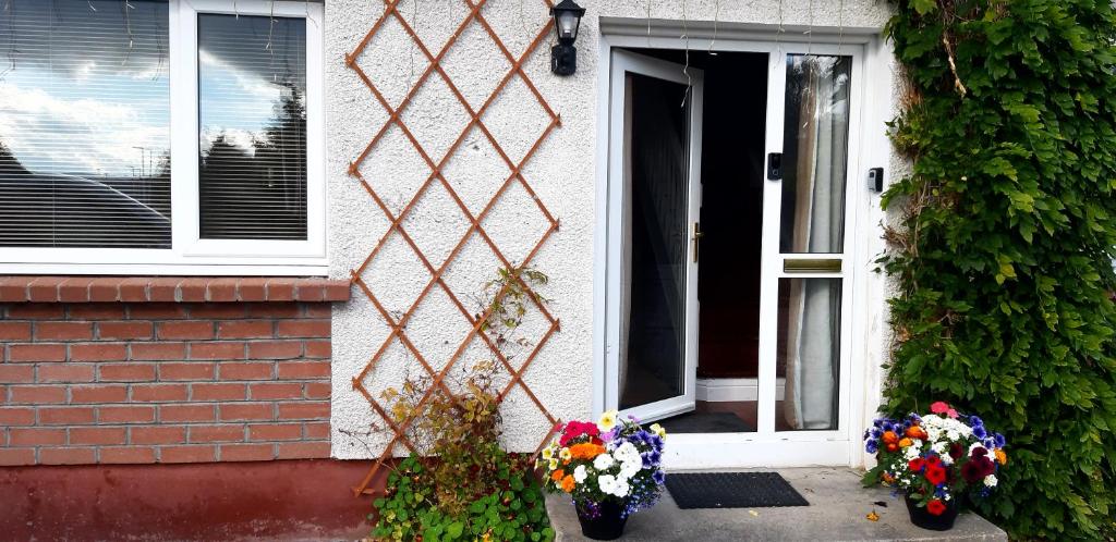 a house with flowers in front of a door at Spacious one bedroom apartment in North Kessock in Inverness