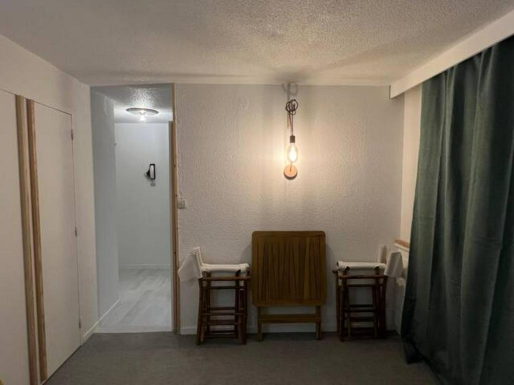 a room with two chairs and a hallway with a door at Modern studio in the heart of the station 1650 in Les Orres