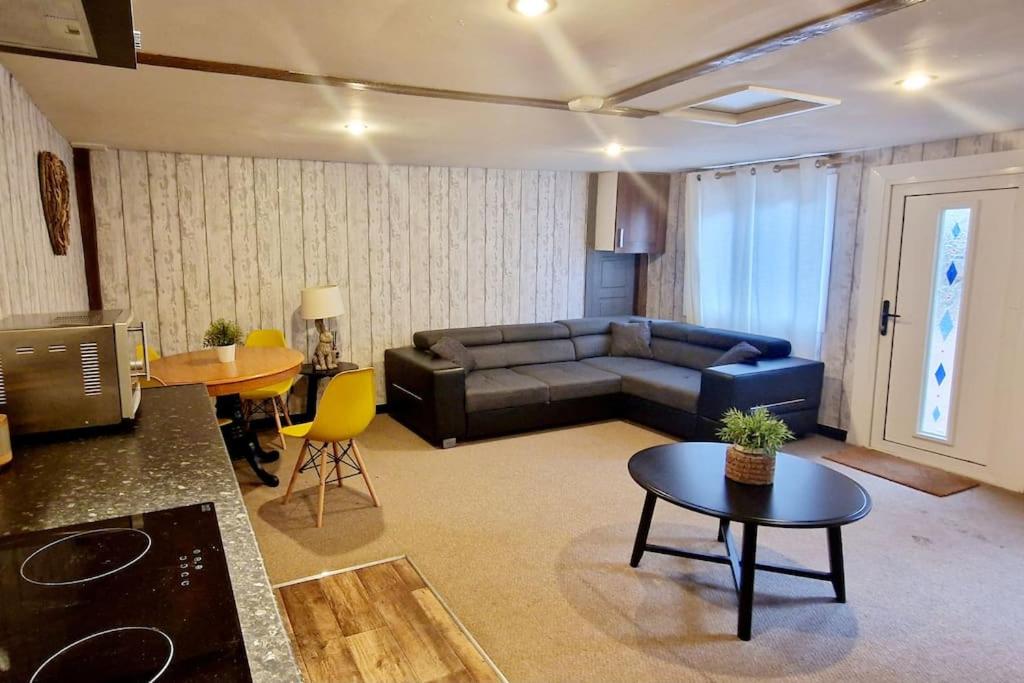 uma sala de estar com um sofá e uma mesa em The Birch Cabin with hot tub em Bristol