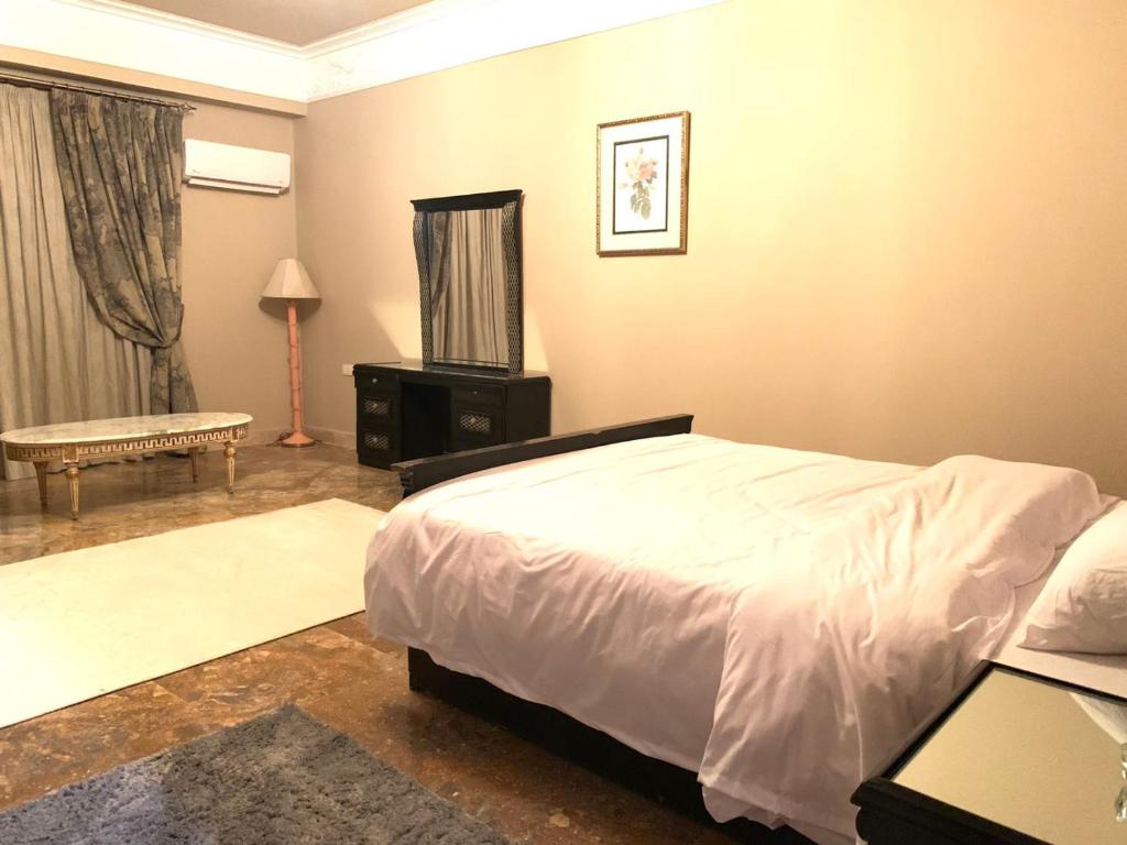 a bedroom with a bed and a television in it at فيلا 