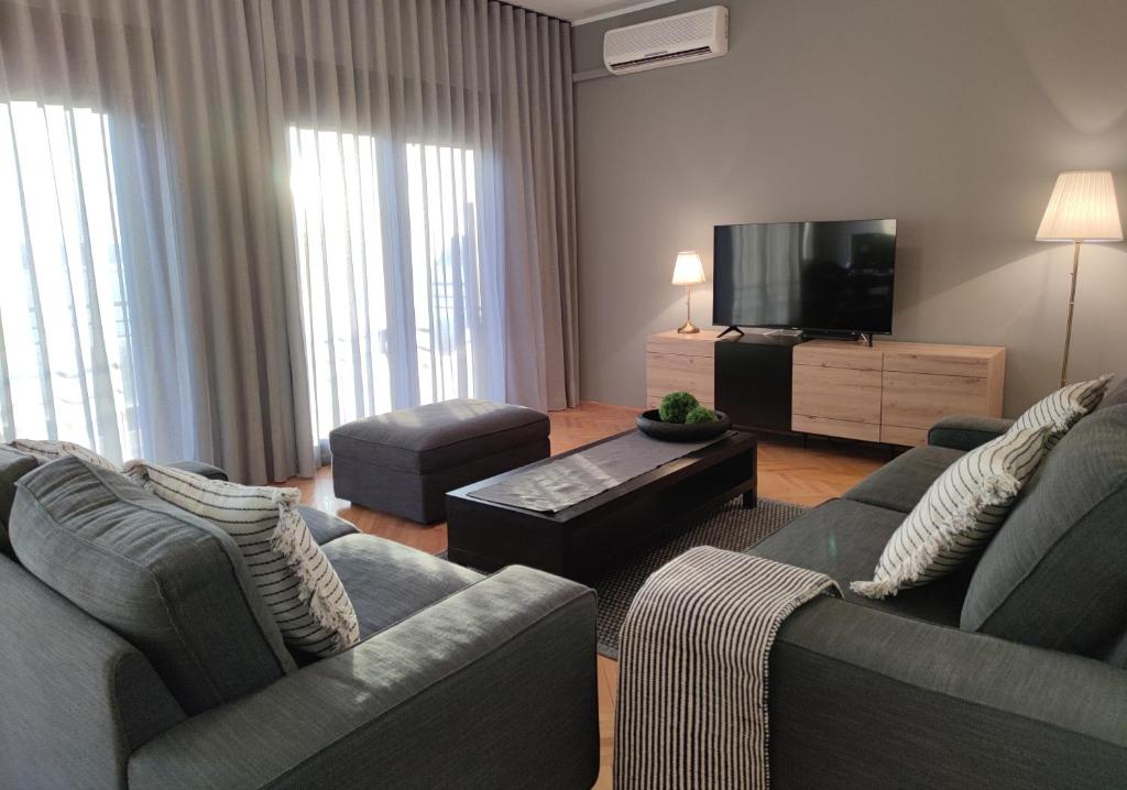a living room with two couches and a flat screen tv at Apartment Valentino in Dramalj