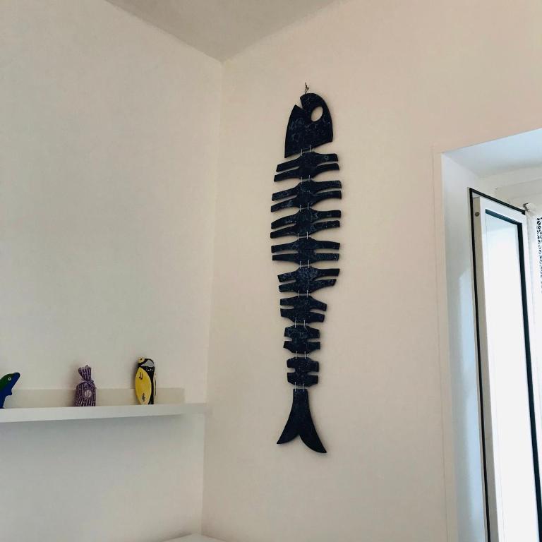 a skeleton hanging on a wall in a room at B&B Via dell'Azzurra in Bari