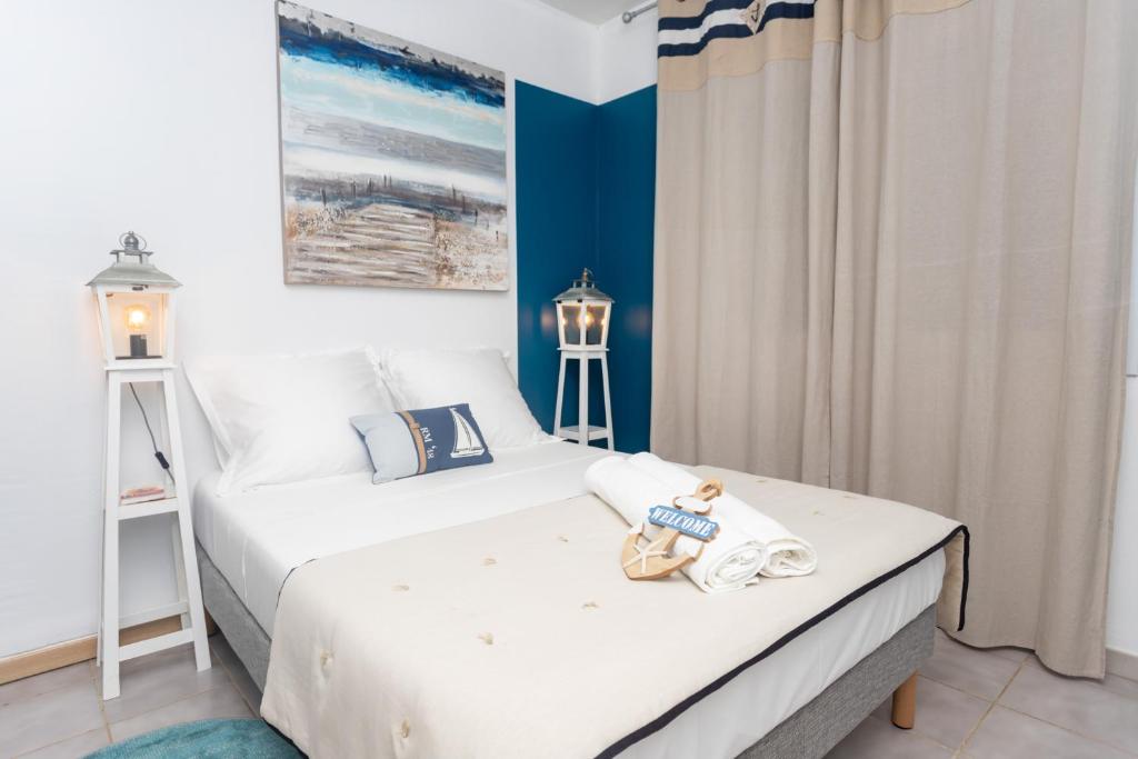 a bedroom with two beds with a teddy bear sitting on it at Le petit marin des salines à 0 metre de la plage in Montjoly