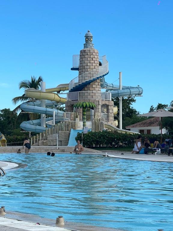 a pool at a resort with a water slide at Hotel Palmera Bayahibe in Bayahibe