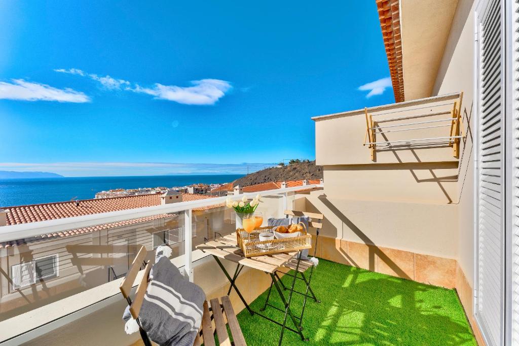 balkon z krzesłami i widokiem na ocean w obiekcie Black Beach Luxury Vacation House w mieście Puerto de Santiago